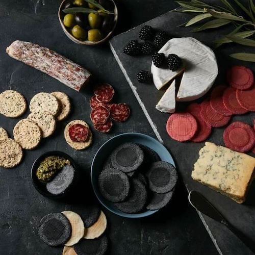 wafer crackers on cheeseboard and charcuterie